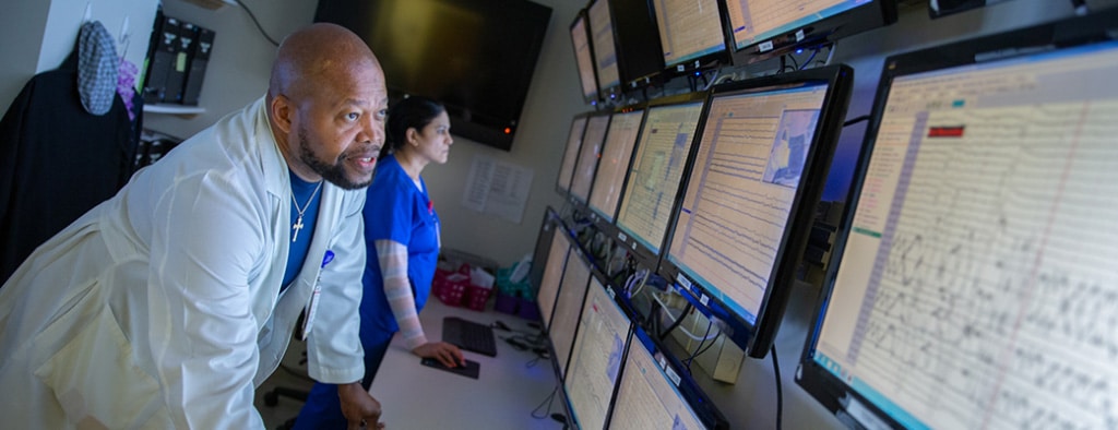 Doctor reviewing scans on a monitor